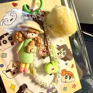 Little girl figure with cookie and apple charm